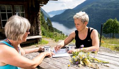 2 ladies sitting at a table at Rui Square looking at a map