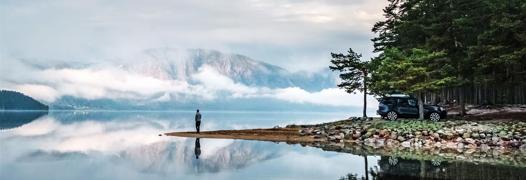 man standing by a lake in Fyresdal