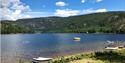 bathing beach with boats for rent at Øyne Camping