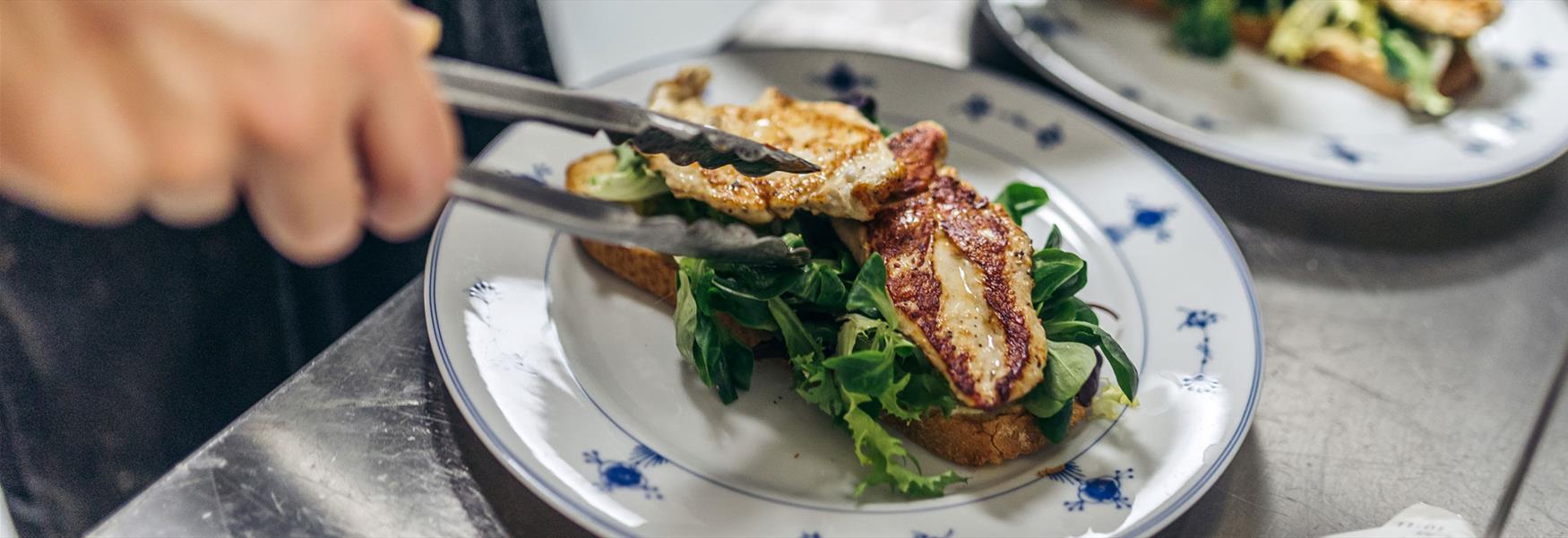 cook puts food on plate